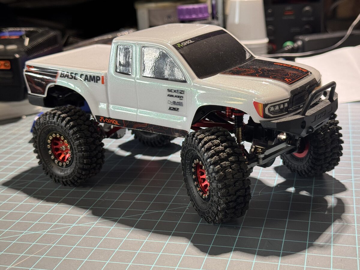 Axial SCX24 Base Camp with white body and red beadlock wheels